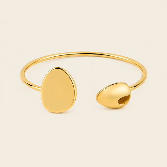 Offset Disc Cuff with an open band with unequal polished disc ends in gold finish