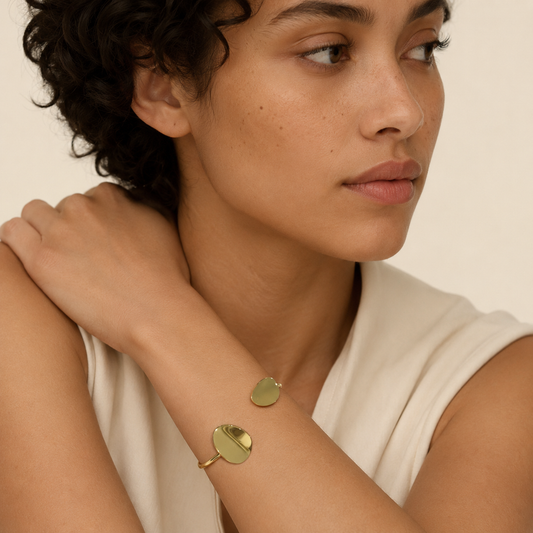 Offset Disc Cuff worn on the wrist in gold finish