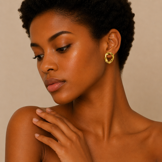 Open Form Earrings worn on the ear in gold finish