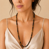 Orbit Strand Necklace worn at the neckline, with small round stone beads