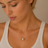 Pearl Embrace Necklace worn at the neckline in gold finish
