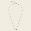 Pearl Embrace Necklace with a central pearl framed by curved metal details in silver finish