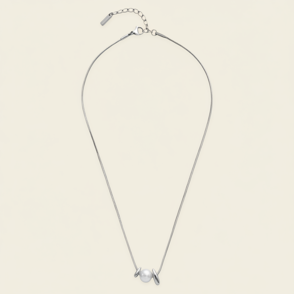 Pearl Embrace Necklace with a central pearl framed by curved metal details in silver finish