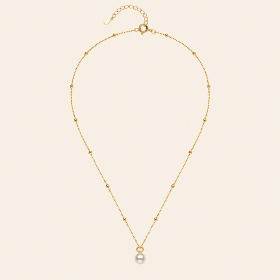 Pearl Trace Necklace with a fine chain and a single pearl drop in gold finish