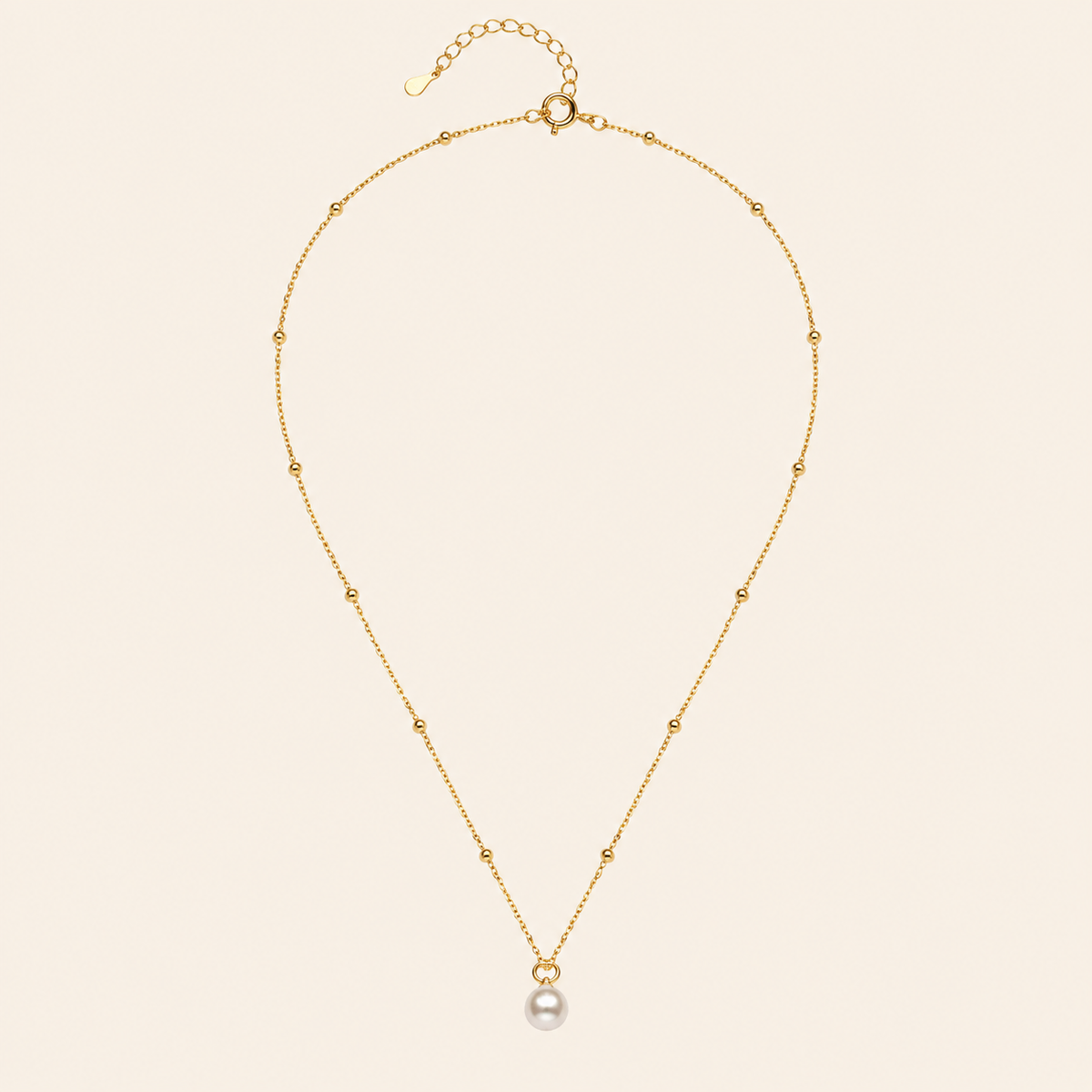 Pearl Trace Necklace with a fine chain and a single pearl drop in gold finish
