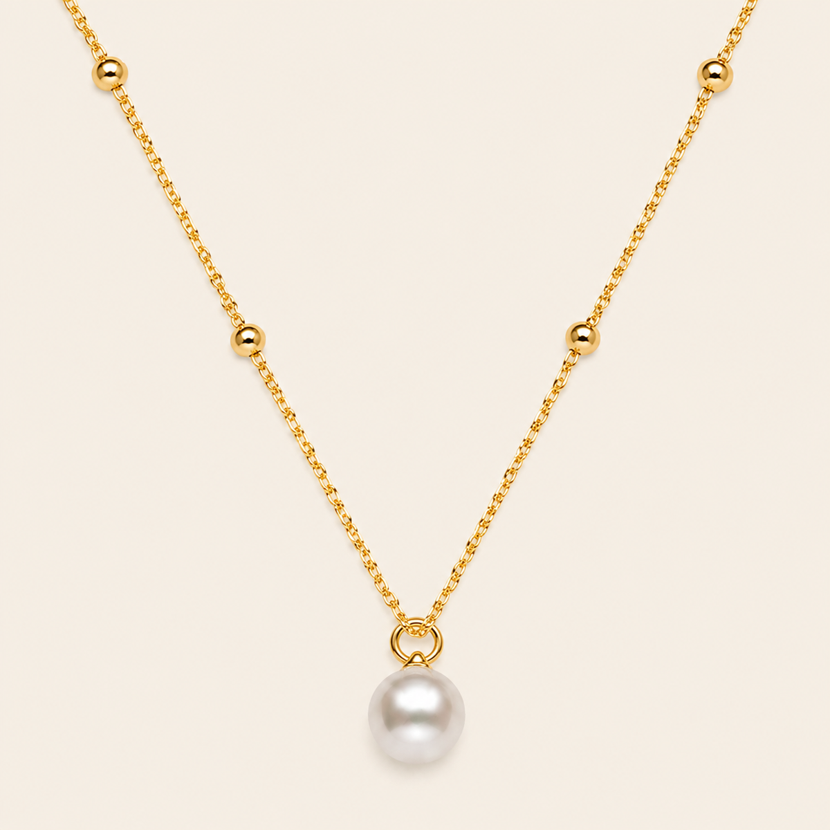 Pearl Trace Necklace with a fine chain and a single pearl drop in gold finish