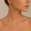 Pearl Trace Necklace worn at the neckline in gold finish