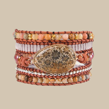 Layered beaded wrap bracelet with an oval earth-toned centre