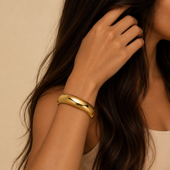 Polished Dome Cuff worn on the wrist in gold finish