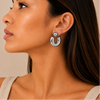 Polished Orbit Earrings worn on the ear in silver finish