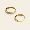 Quiet Arc Earrings with smooth oval hoops in gold finish