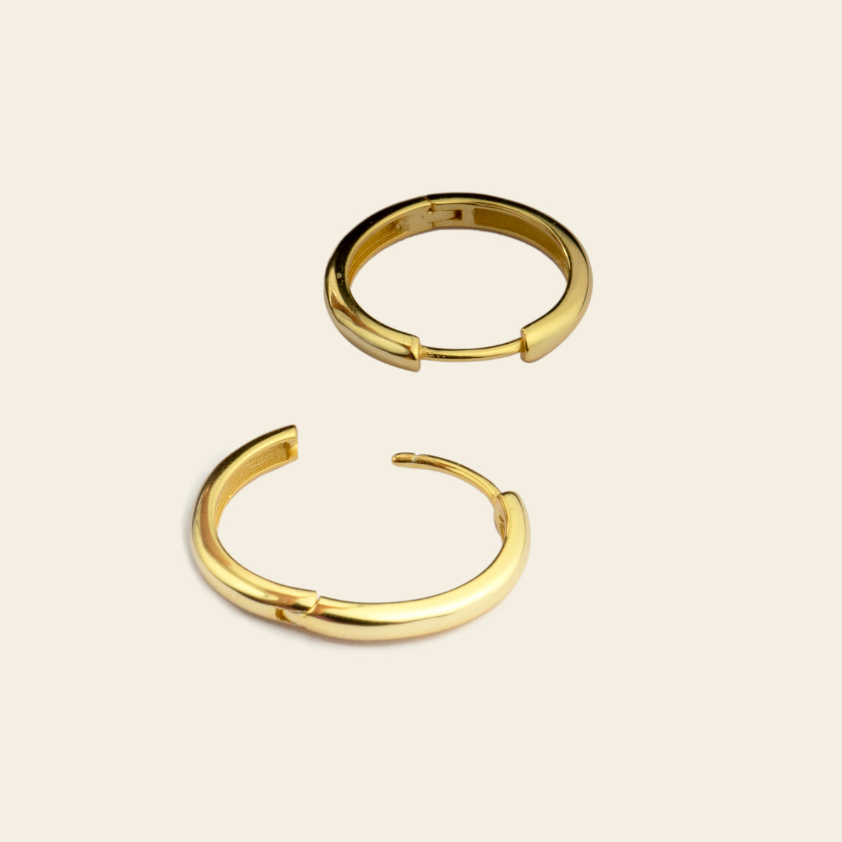 Quiet Arc Earrings with smooth oval hoops in gold finish