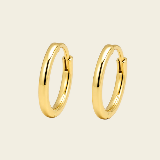 Quiet Arc Earrings with smooth oval hoops in gold finish