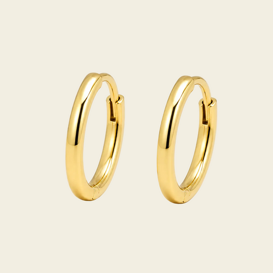 Quiet Arc Earrings with smooth oval hoops in gold finish