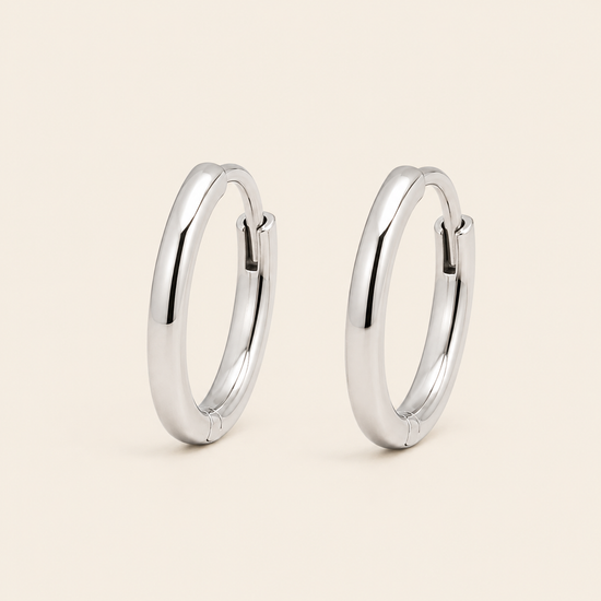 Quiet Arc Earrings with smooth oval hoops in silver finish