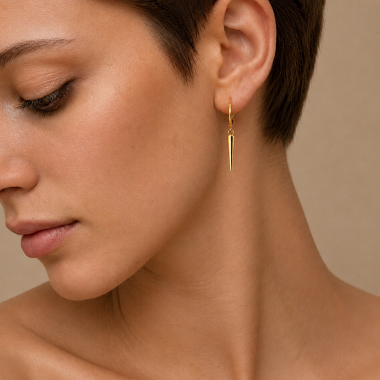Quiet Edge Earrings worn on the ear in gold finish