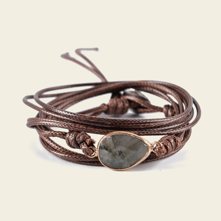 Quiet Ember Bracelet with a grey stone centre on layered brown cord