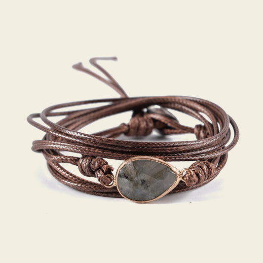 Quiet Ember Bracelet with a grey stone centre on layered brown cord