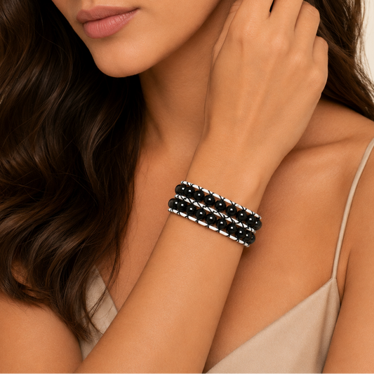 Quiet Form Bracelet worn on the wrist, with round beads woven onto contrasting cord