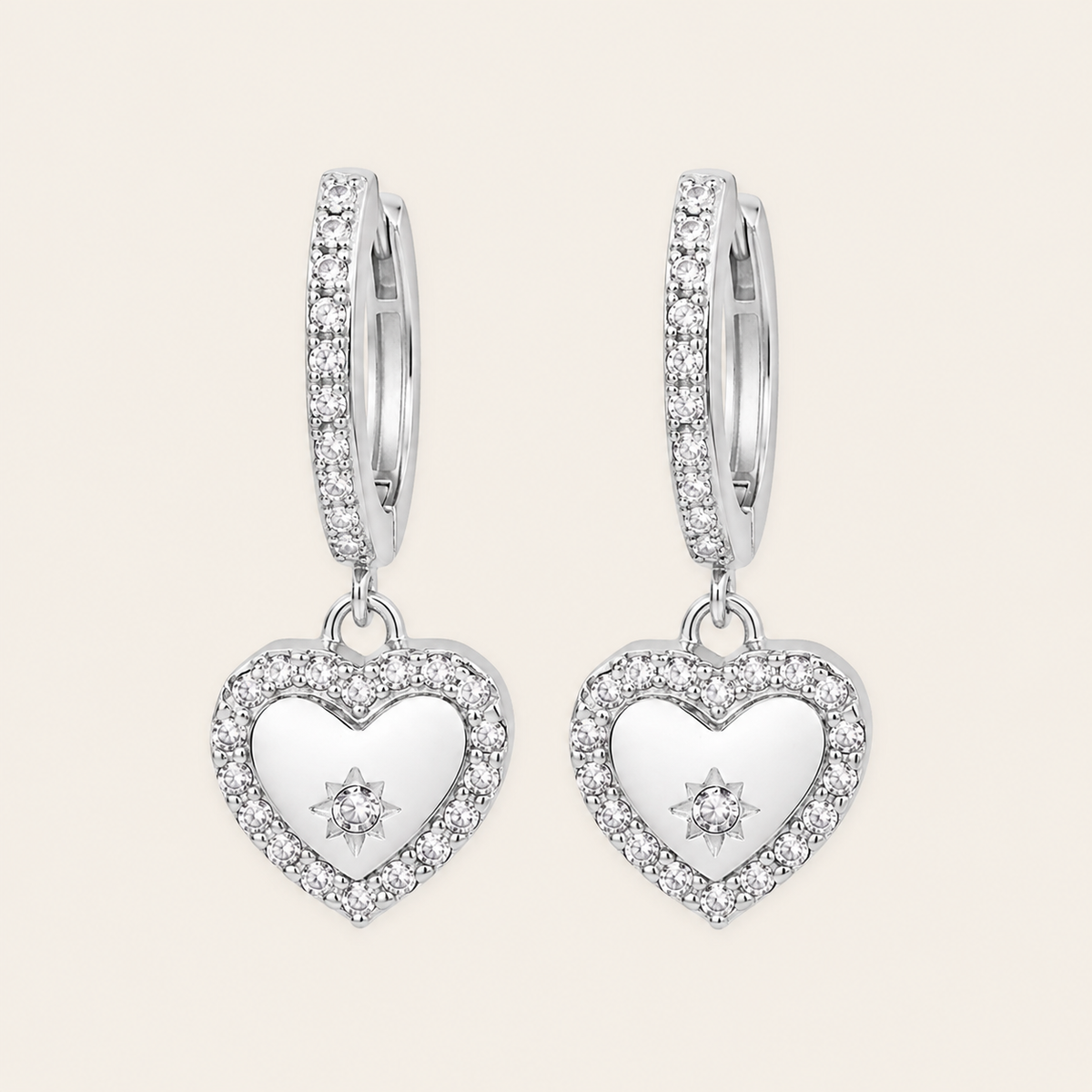 Quiet Heart Earrings with heart-shaped charms on small hoops in silver finish