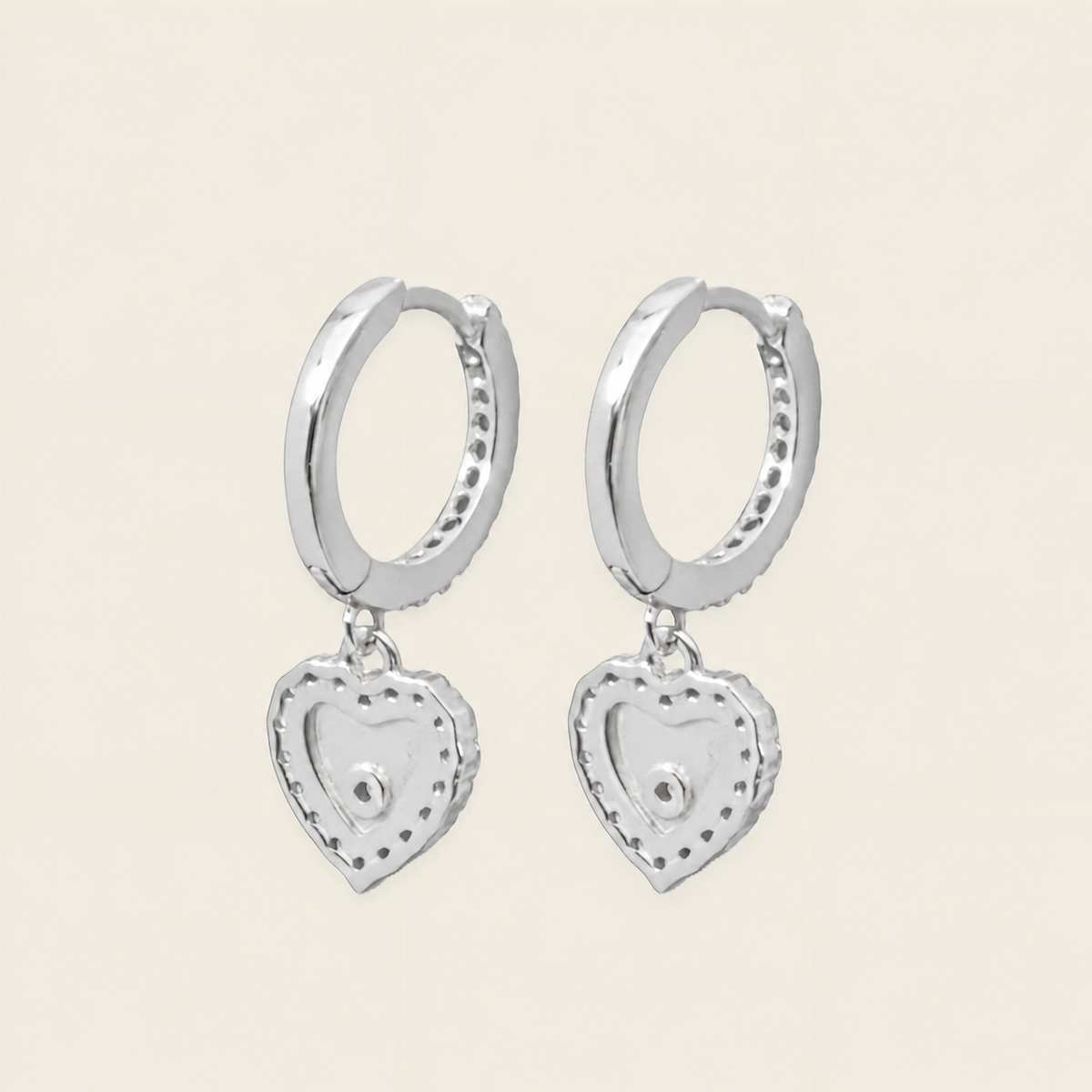 Quiet Heart Earrings with heart-shaped charms on small hoops in silver finish