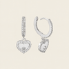 Quiet Heart Earrings with heart-shaped charms on small hoops in silver finish