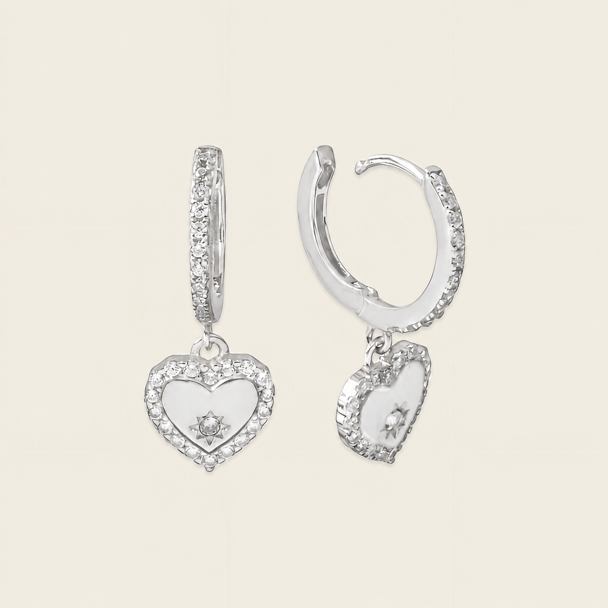 Quiet Heart Earrings with heart-shaped charms on small hoops in silver finish