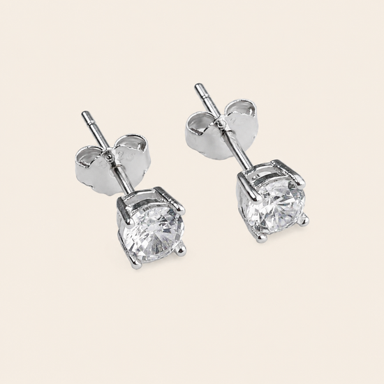Quiet Light Earrings with clear cushion-shaped stud settings in silver finish