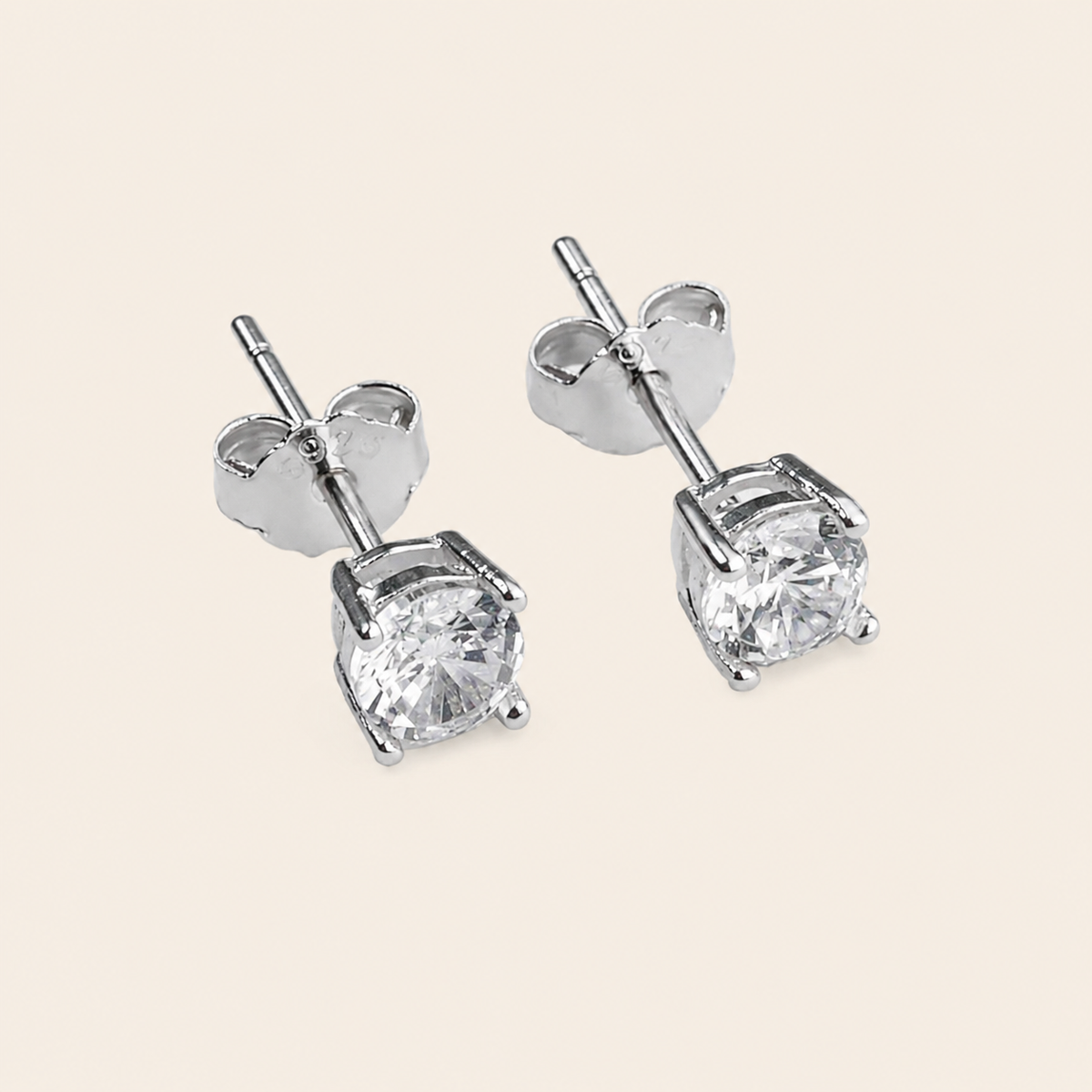 Quiet Light Earrings with clear cushion-shaped stud settings in silver finish