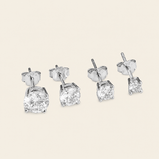 Quiet Light Earrings with clear cushion-shaped stud settings in silver finish
