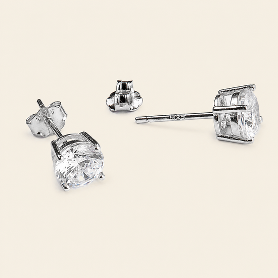 Quiet Light Earrings with clear cushion-shaped stud settings in silver finish