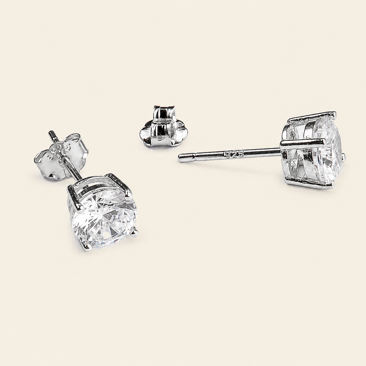Quiet Light Earrings with clear cushion-shaped stud settings in silver finish