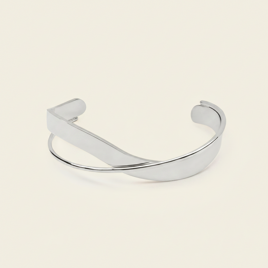 Ribbon Sweep Cuff with a broad open band with overlapping curved lines in gold finish