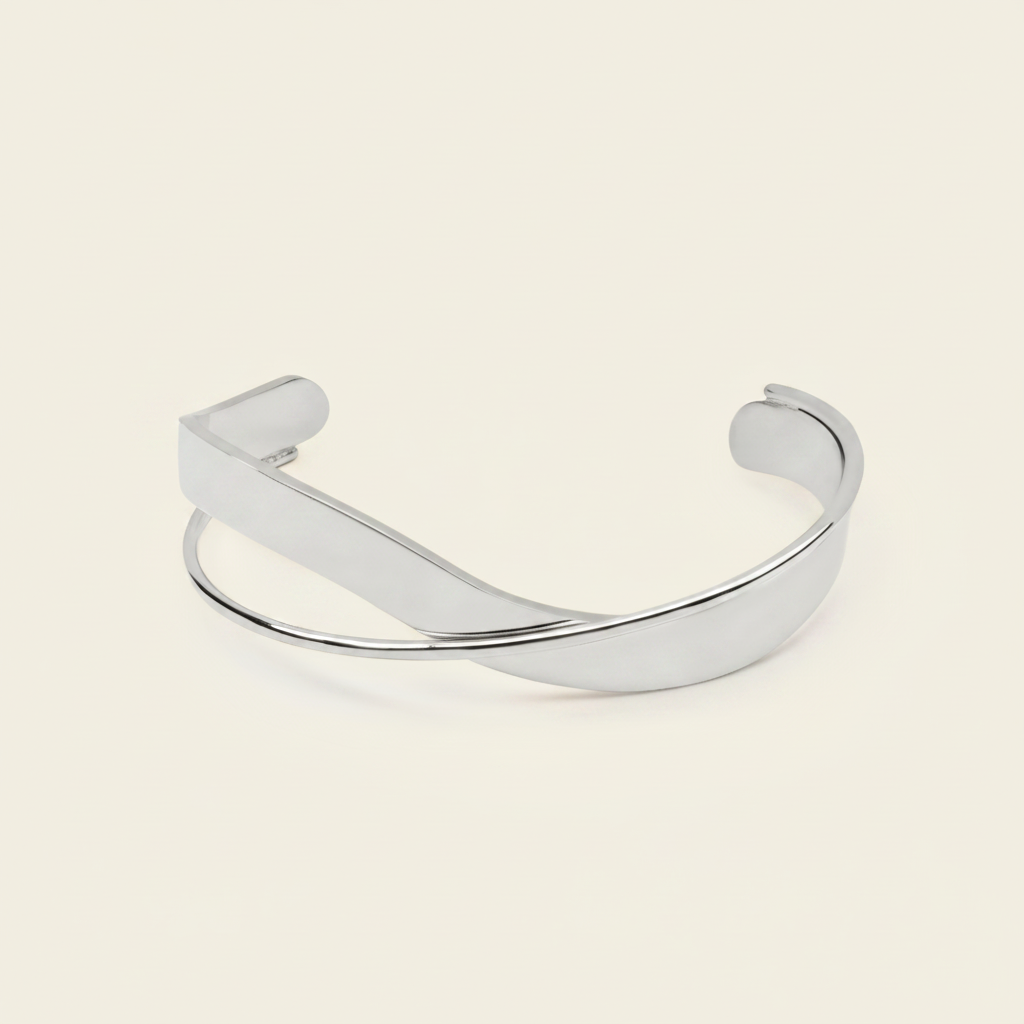 Ribbon Sweep Cuff with a broad open band with overlapping curved lines in gold finish