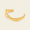 Ribbon Sweep Cuff with a broad open band with overlapping curved lines in gold finish