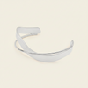Ribbon Sweep Cuff with a broad open band with overlapping curved lines in gold finish