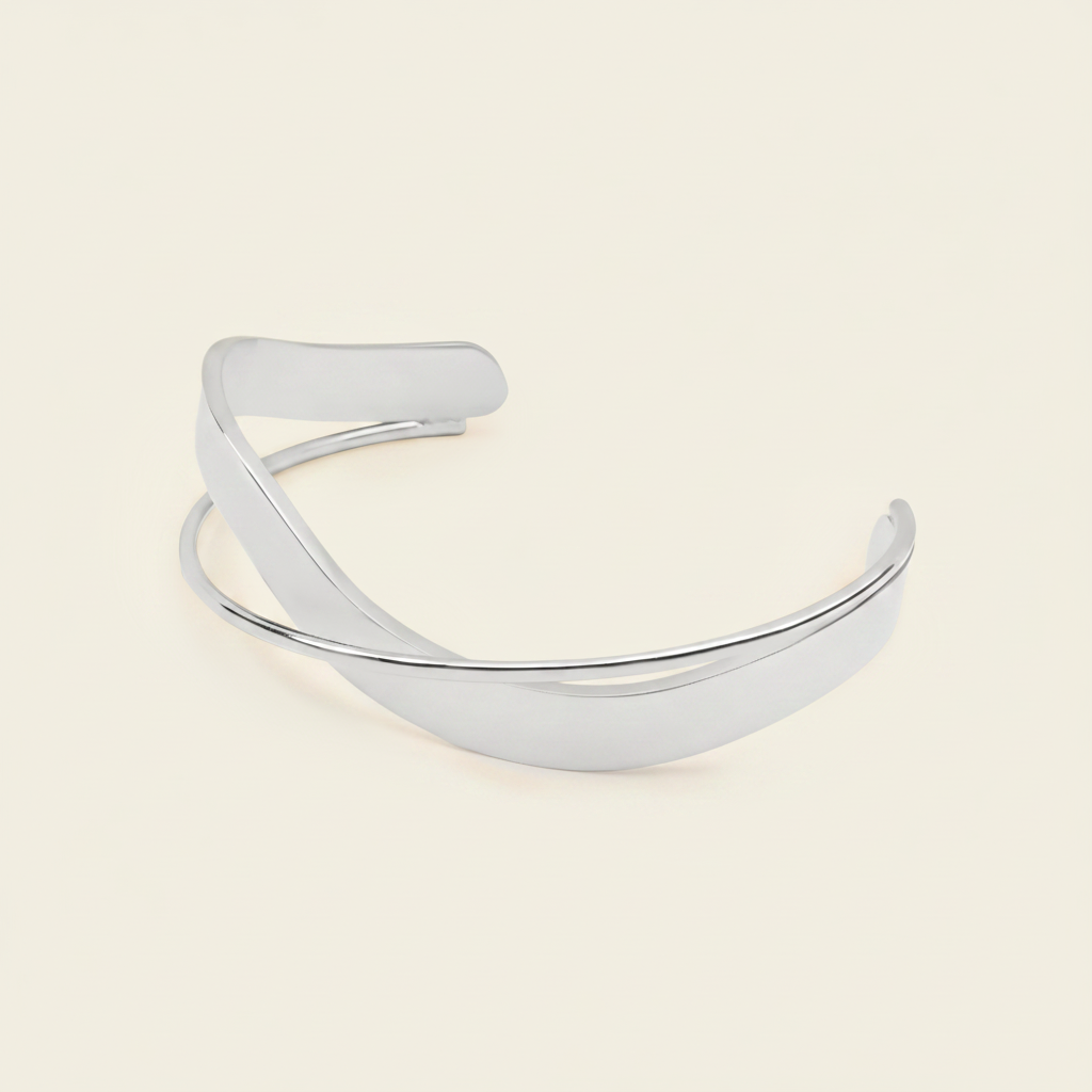 Ribbon Sweep Cuff with a broad open band with overlapping curved lines in gold finish
