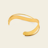 Ribbon Sweep Cuff with a broad open band with overlapping curved lines in gold finish