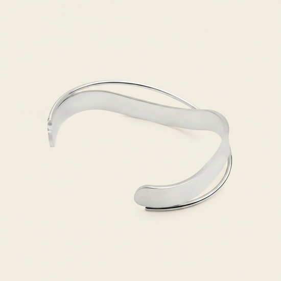 Ribbon Sweep Cuff with a broad open band with overlapping curved lines in gold finish