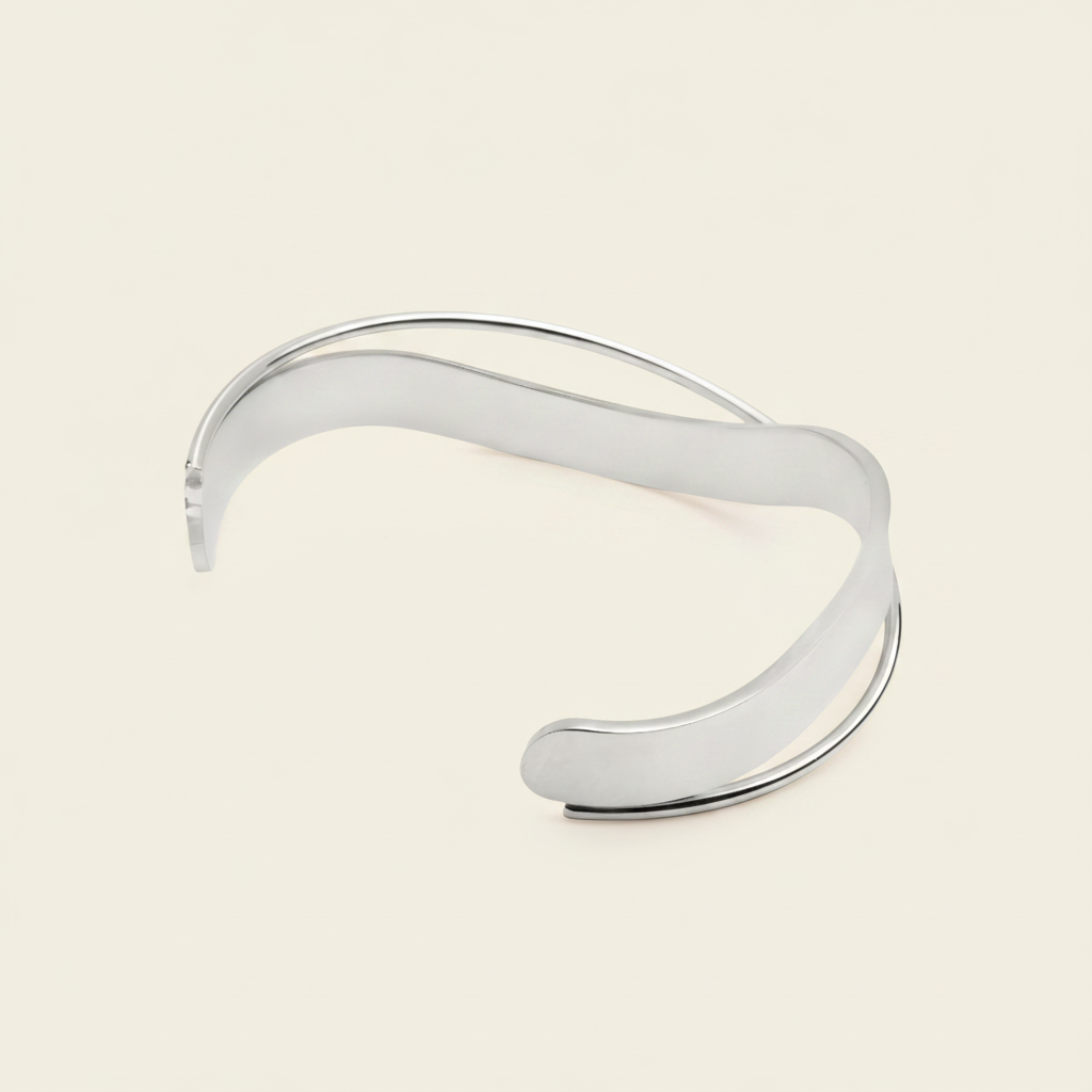Ribbon Sweep Cuff with a broad open band with overlapping curved lines in gold finish