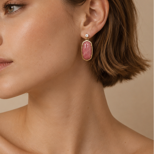 Rose Hold Earrings worn on the ear, with long pink stone drops in gold-coloured settings