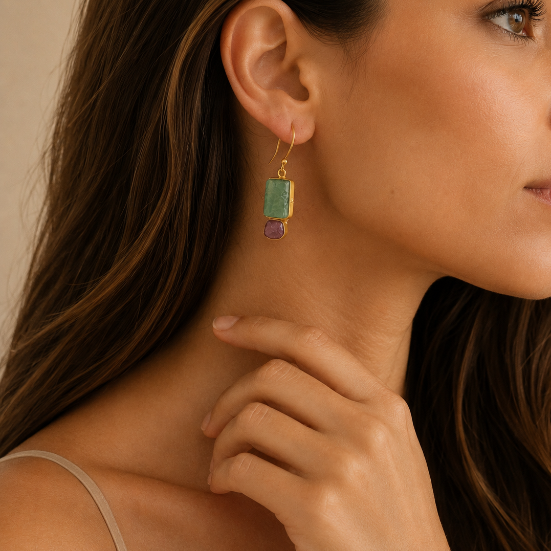 Ruby Meadow Earrings worn on the ear, with green rectangular stones and purple drops