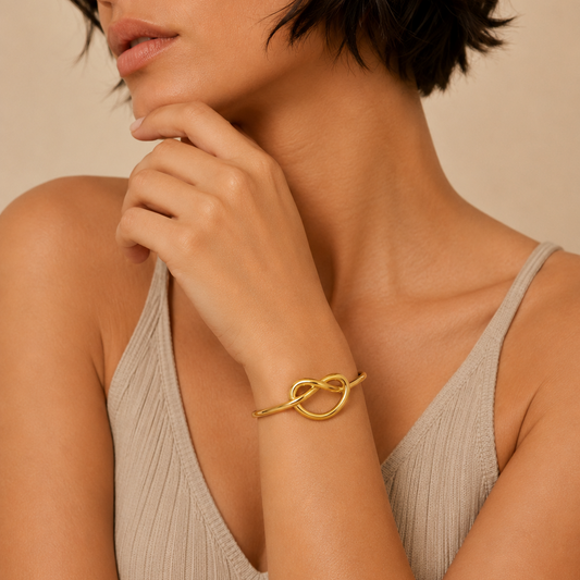 Sculpted Knot Cuff worn on the wrist in gold finish