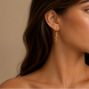 Serpent Drop Earrings worn on the ear in gold finish