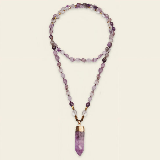 Signal Drift Necklace with purple beads and a pointed purple pendant