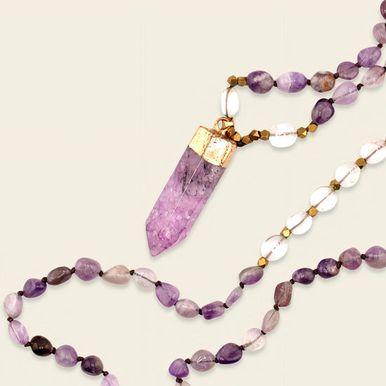 Signal Drift Necklace with purple beads and a pointed purple pendant