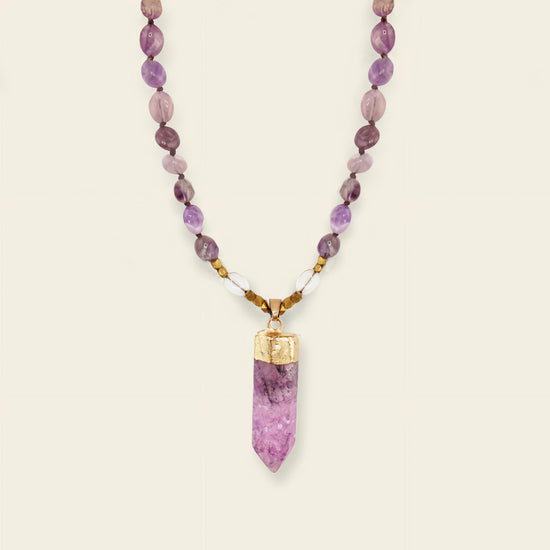 Signal Drift Necklace with purple beads and a pointed purple pendant