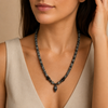 Skull Drift Necklace worn at the neckline, with round stone beads and skull-shaped accents