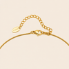 Slender Arc Necklace with a fine chain and slender curved bar in gold finish
