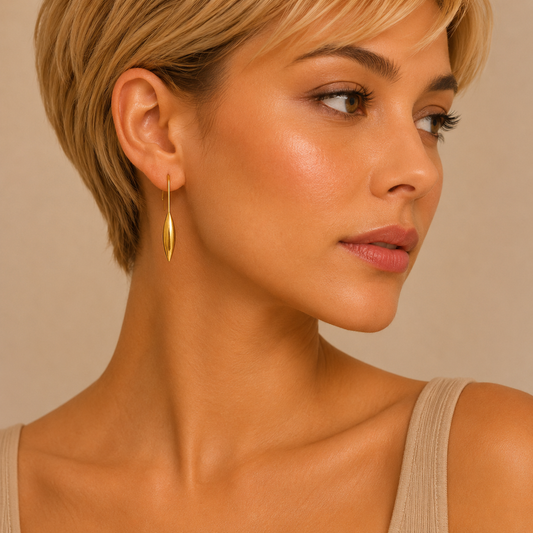Slender Leaf Earrings worn on the ear in gold finish